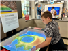 Boy playing with sand display at Gateway to Science. 