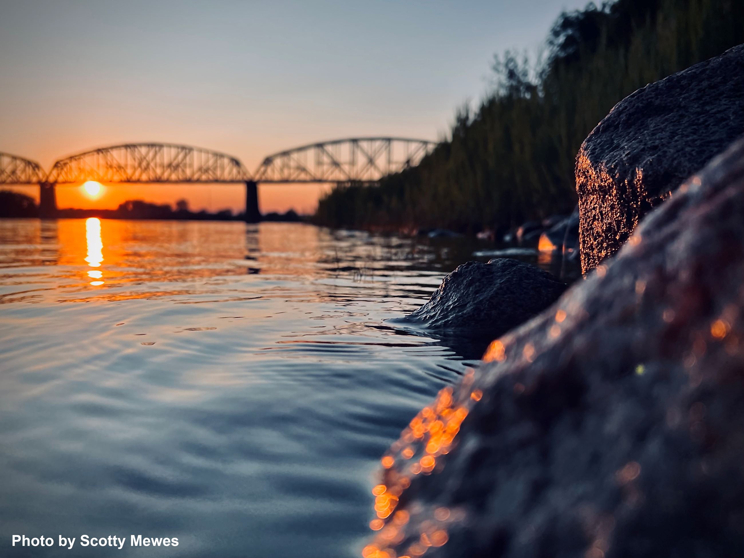 A bridge is shown over a river. 