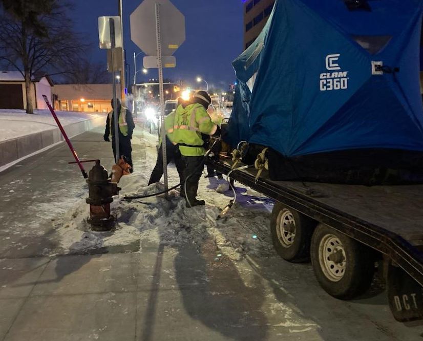 Senior Project Engineer Michael Mart works with contracted staff near a fire hydrant. 