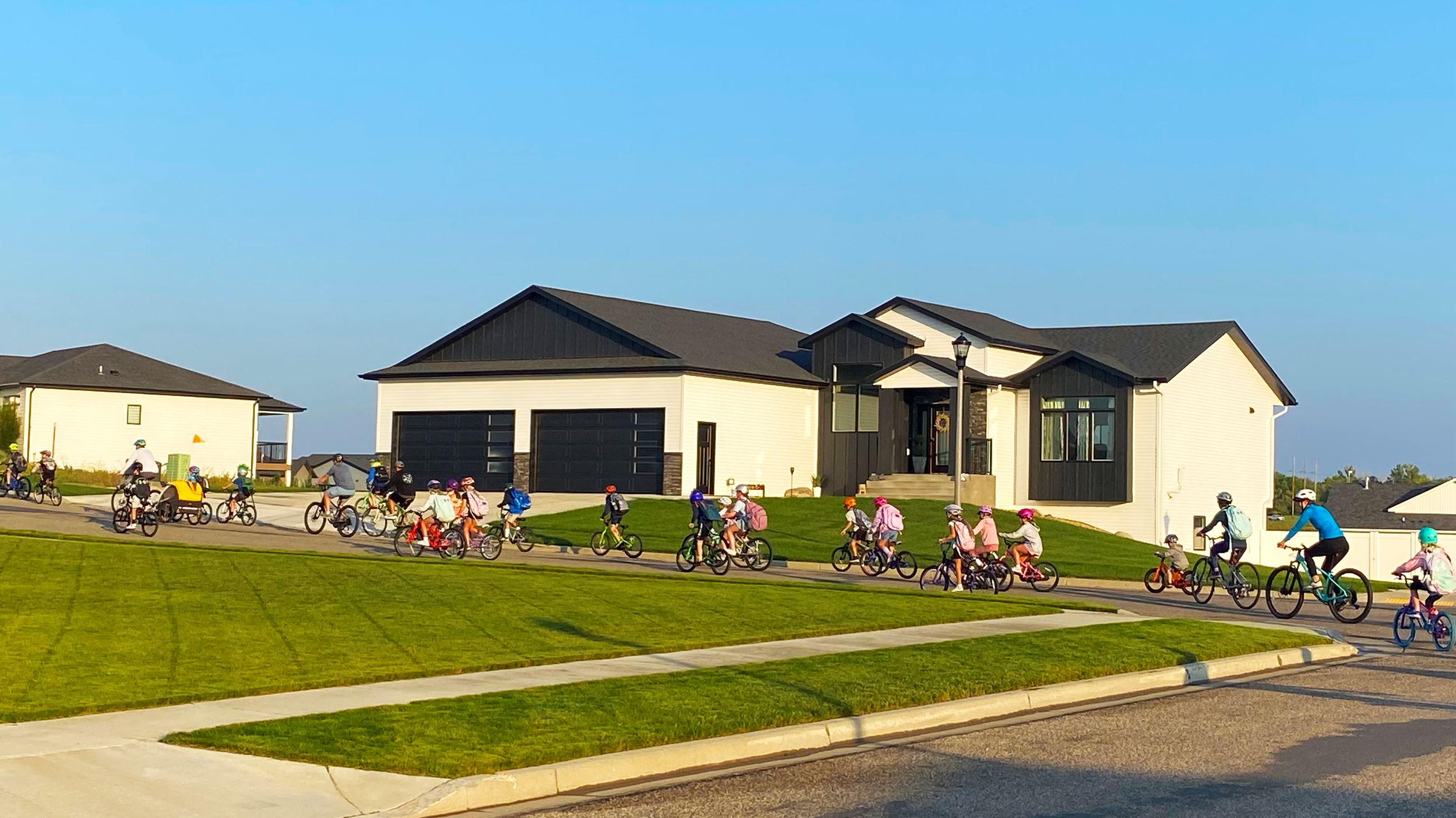Children and adults riding bicycles through Bismarck